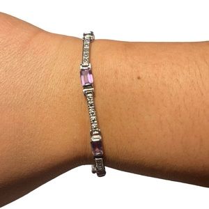 Purple gems with a silver base clasp tennis bracelet